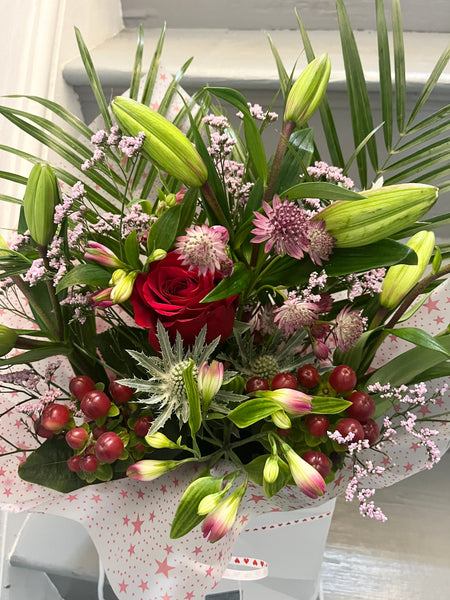 Bag of mixed flowers with single red rose