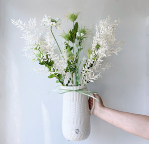 Faux flower bouquet in a ceramic cream tall jug