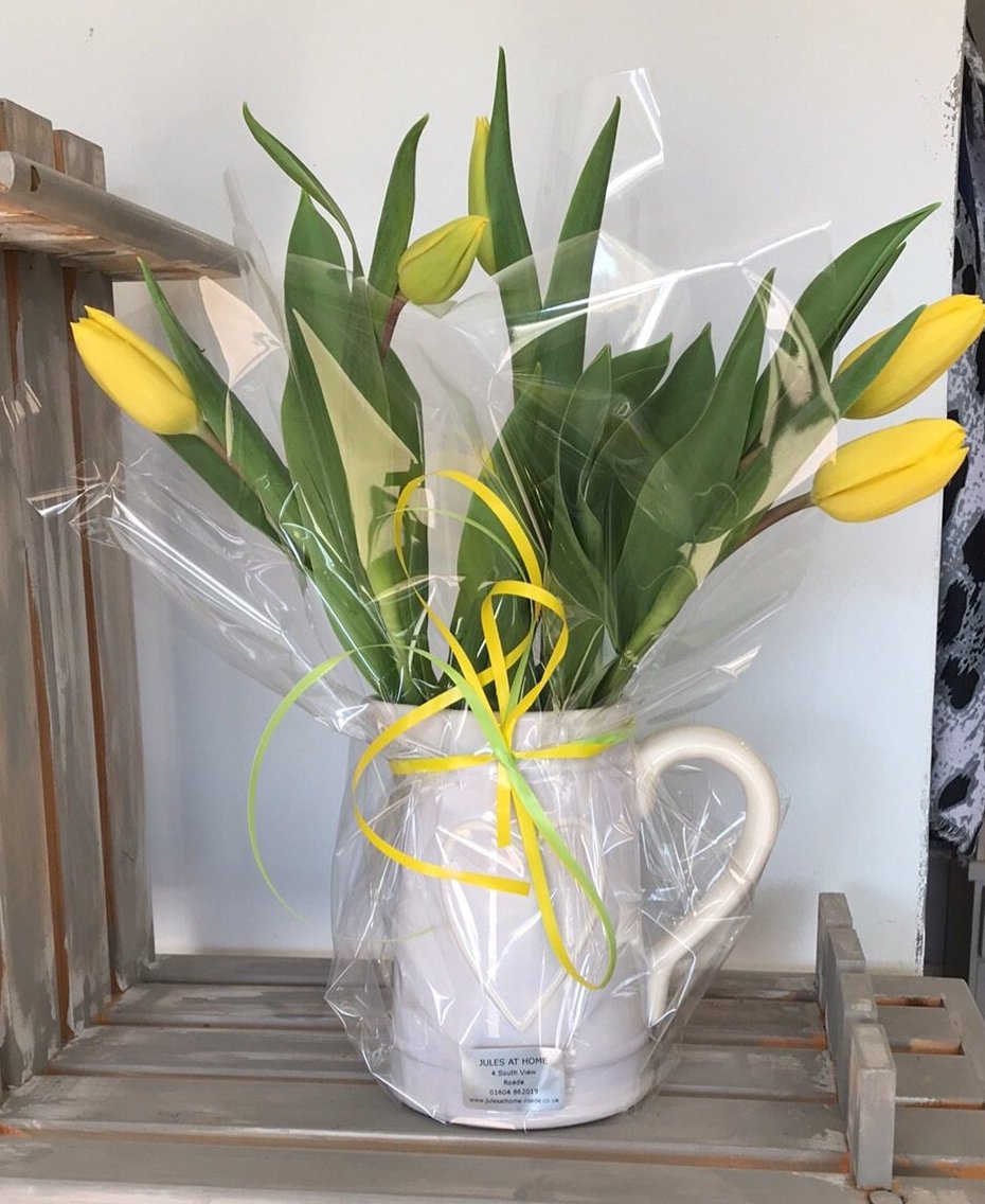 Jug or vase of yellow tulips