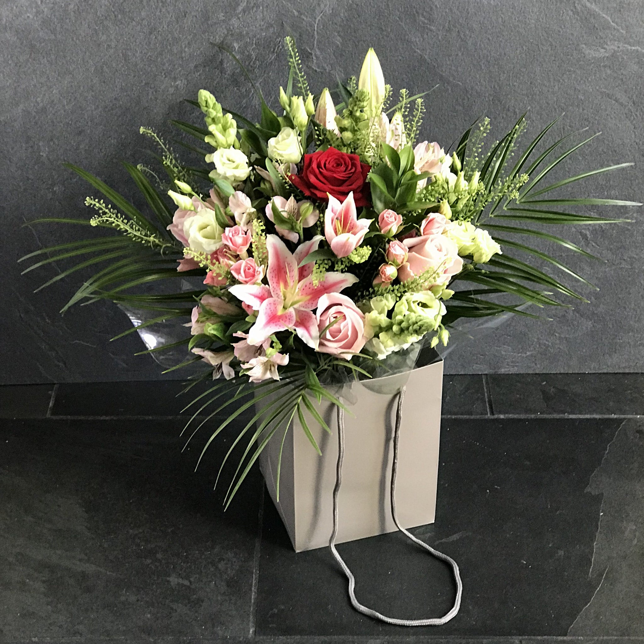 Mixed bag of flowers in oasis with Luxury Red Rose ( if available) in gift bag
