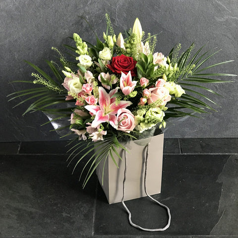 Mixed bag of flowers in oasis with Luxury Red Rose ( if available) in gift bag