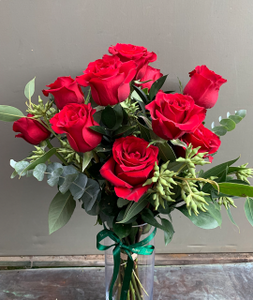 Dozen red roses bouquet with foliage